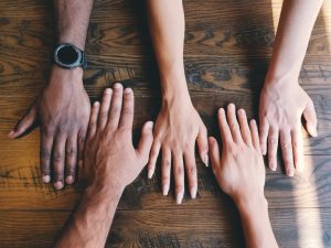 A photo of different hands celebrating multiculturalism