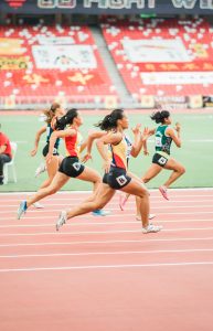 Women running on track field