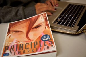 Principles of Marketing textbook cover and keyboard